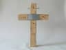 Simple natural wood provisional grave cross with an empty metal nameplate, no text