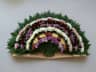 Semicircular funeral sheaf of carnations and chrysanthemums laid on the ground