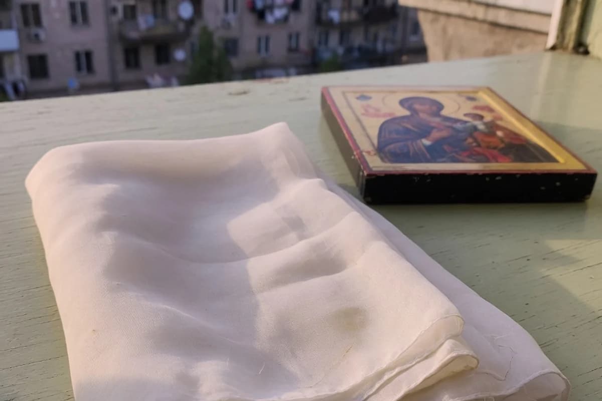 Folded white veil beside a small icon, no readable details, Sector 2, Bucharest