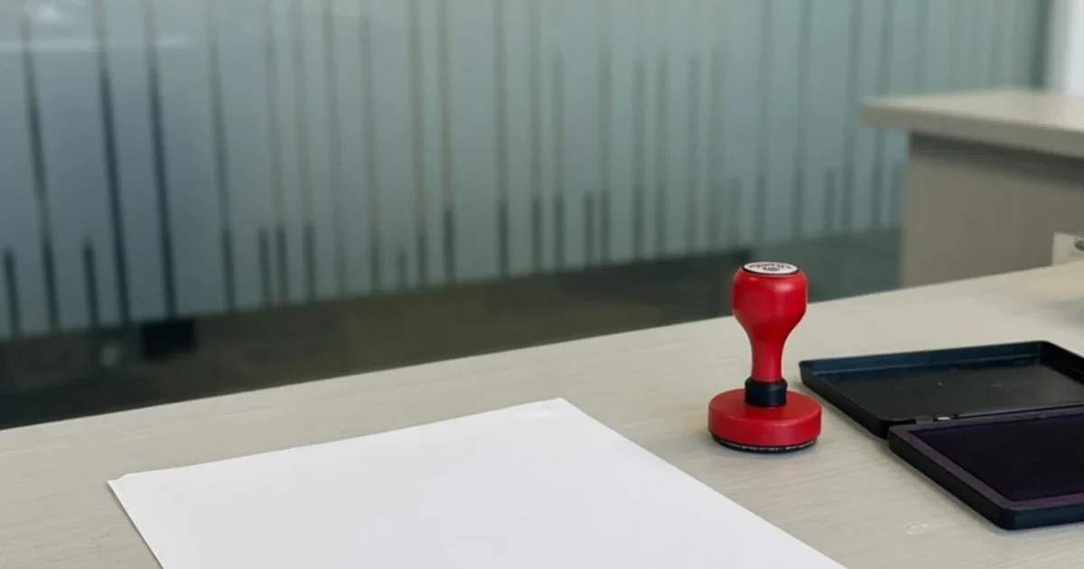 Modern civil registry counter: document, stamp and ink pad