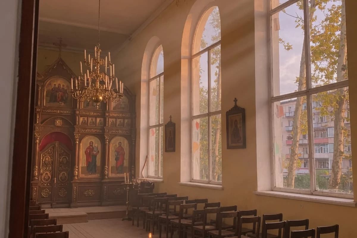 Interior cald de biserică ortodoxă, cu raze de lumină prin ferestre, Sectorul 1, București