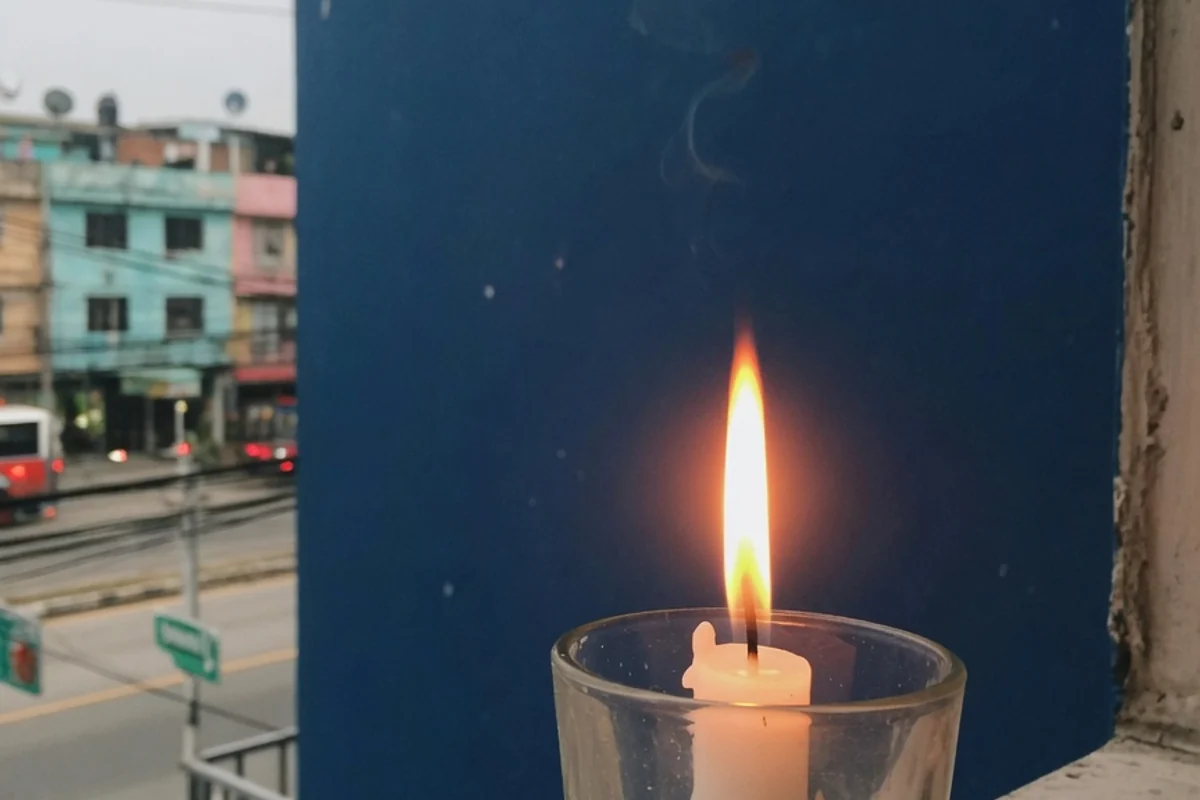 Lumânare albă aprinsă pe fundal albastru închis, Sectorul 3, București