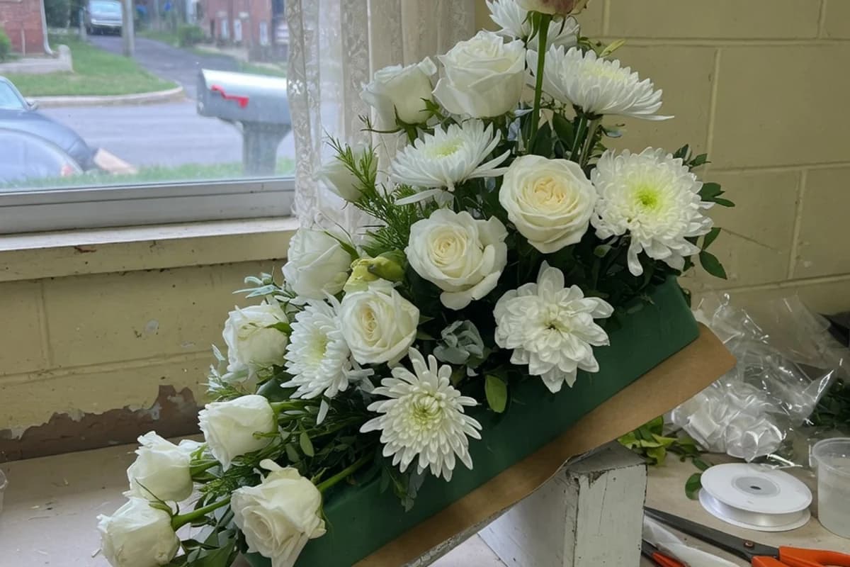White floral arrangement on a catafalque, soft light, Sector 6, Bucharest